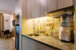 a kitchen with a sink and a counter top at THE SUITE by The Hiltons in Bacolod