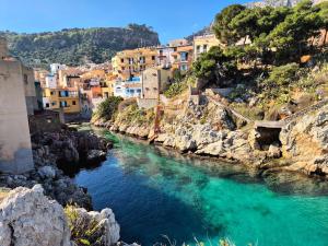 a view of a river with houses on a mountain at Dimora Filangeri in Santa Flavia