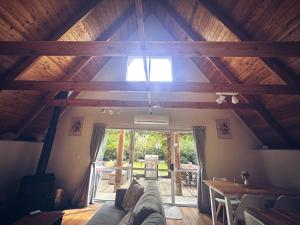 a living room with a couch and a table at Aurora A-Frame Twizel in Twizel