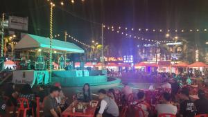 a crowd of people sitting at tables at an event at Pension Natividad in Manila
