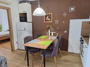 a kitchen and dining room with a wooden table and chairs at Apartma San Izola - near the beach San Simon in Izola