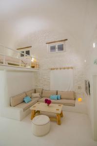 a living room with a couch and a table at Yialos Ios Hotel in Ios Chora