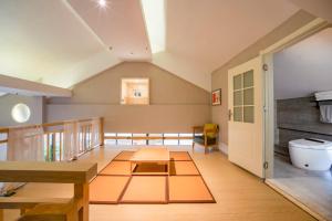an attic room with a table and a bench at Phoenix Dragon M.I.C.E Hotel in Kunming +141 photos