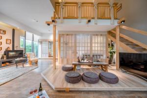 a living room with wooden floors and a staircase at Phoenix Dragon M.I.C.E Hotel in Kunming