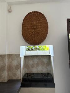 a basket hanging above a stove in a kitchen at John's Homestay in Talpe +92 photos