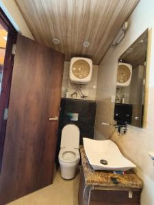a bathroom with a toilet and a sink at Golden Glow Stays in Shimla
