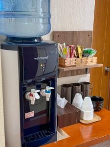a coffee maker sitting on top of a refrigerator at Chouchinya in Nozawa Onsen +9 photos