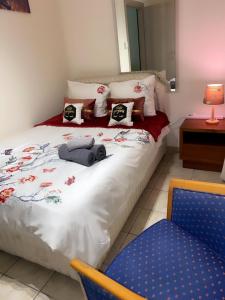a bedroom with a bed and a blue chair at Larnaca Beach Apartment in Larnaca