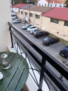 a balcony with cars parked in a parking lot at Larnaca Beach Apartment in Larnaca +5 photos