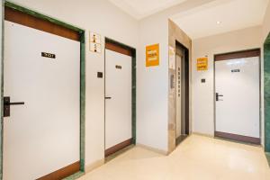a row of elevator doors in a building at Itsy Hotels Lotus Executive in Pune