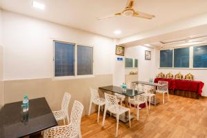 a room with two tables and chairs and a table and a table and chairsktop at Itsy Hotels Lotus Executive in Pune