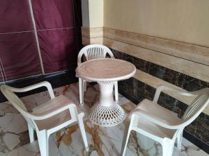 a table and two chairs and a table and chairs at Shobhit homestay in Amroha