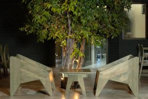 a table and two chairs next to a tree at VerdEra Wild - Wilpattu in Wilpattu
