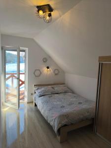 a bedroom with a bed and a large window at Przystanek Prządki in Czarnorzeki