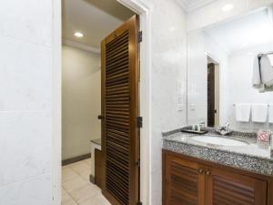 a bathroom with a sink and a mirror at Copa Hotel in Pattaya