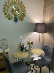 a dining room with a glass table and a clock at AHN Haven in Sampong