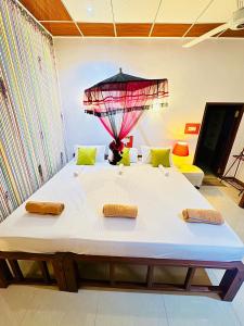 a large bed with two pillows on top of it at Freedom Cottage & Safari in Tissamaharama