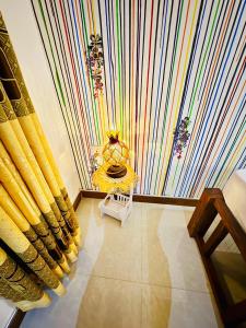 a room with a colorful curtain and a table at Freedom Cottage & Safari in Tissamaharama +61 photos