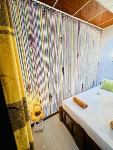 a bedroom with a bed with a curtain and a bedskirtspectspectspectspects at Freedom Cottage & Safari in Tissamaharama