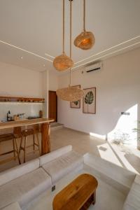 a living room with a couch and a table at Nyaman lima Villas in Canggu