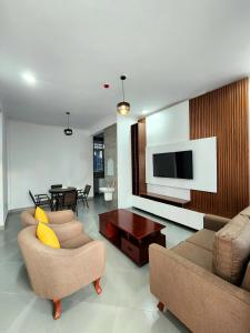 a living room with two couches and a table at Karibu Haven Apartments in Arusha