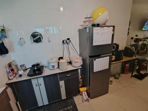 a kitchen with a desk and a refrigerator in a room at Private Room in Condominium - Sandakan Friend House in Sandakan