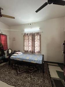 a bedroom with a bed in a room with a window at Hostel Honsa in Cochin