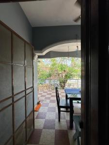 a dining room with a table and a view of a room at Hostel Honsa in Cochin +5 photos