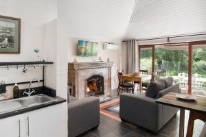 a kitchen and a living room with a fireplace at Ardmore Guest Farm in Champagne Valley
