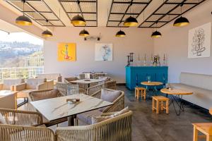 a restaurant with tables and chairs and a view at First Joy Hotel in Trabzon