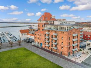 an aerial view of a large brick building with a green lawn at Lütt Haven in Barth