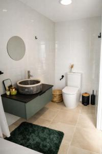 a bathroom with a sink and a toilet at O Cabanel in Fisterra +37 photos