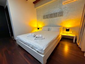a bedroom with a bed with two towels on it at Sibiutiful - Ultracentral in Sibiu +18 photos
