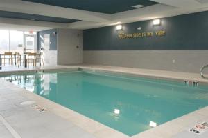 a swimming pool with blue water in a building at Home2 Suites By Hilton Lima in Lima +10 photos