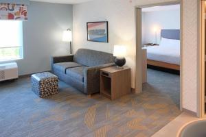a hotel room with a couch and a bed at Home2 Suites By Hilton Lima in Lima