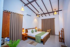a bedroom with a bed in a room at The Clouds Ahangama in Ahangama