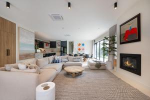 a living room with white furniture and a fireplace at The Hudson with Heated Pool in Rye