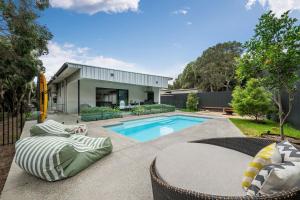 a backyard with a swimming pool and a house at The Hudson with Heated Pool in Rye