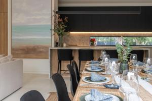 a dining room with a long table with plates and glasses at The Hudson with Heated Pool in Rye