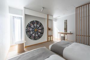 a bedroom with a bed and a mirror on the wall at BnA Alter Museum in Kyoto