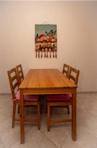 a wooden table with two chairs and a painting on the wall at Villa Ilias in Flogita +50 photos