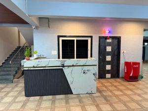 a lobby with a counter and a door in a building at G square The Premium Hotel in Rushikonda