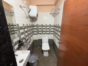 a bathroom with a toilet and a sink at G square The Premium Hotel in Rushikonda +30 photos