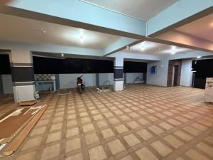 a large room with a wooden floor and a stage at G square The Premium Hotel in Rushikonda