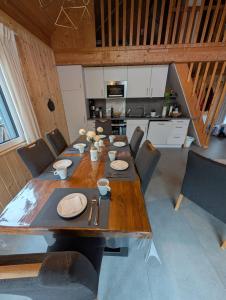 a large wooden table in a room with a kitchen at KREIDESEE 47 - Hemmoor in Hemmoor