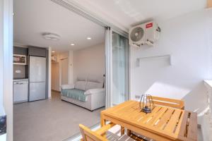a living room with a table and a couch at Playa Honda Design, Comfort & Pool in Playa de las Americas