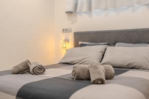 a bedroom with two beds with towels on them at Playa Honda Design, Comfort & Pool in Playa de las Americas +19 photos