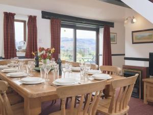 a dining room with a large wooden table with chairs at 8 Bed in Cumbria oc-sz373 in Applethwaite