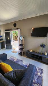 a living room with a couch and a flat screen tv at 14 on Maroela in Polokwane