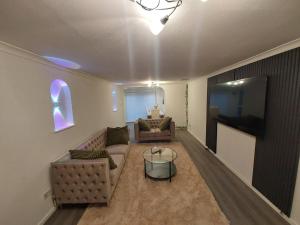 a living room with two couches and a tv at Private Home Grays in Orsett